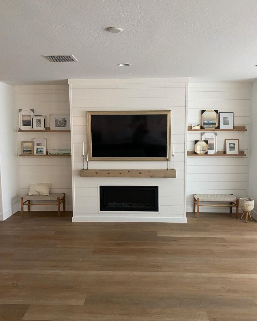 Light wood-colored luxury vinyl plank flooring in a modern living room with a white fireplace.