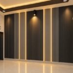 Dark grey fluted PVC wall panels with vertical warm LED light strips in a modern room.