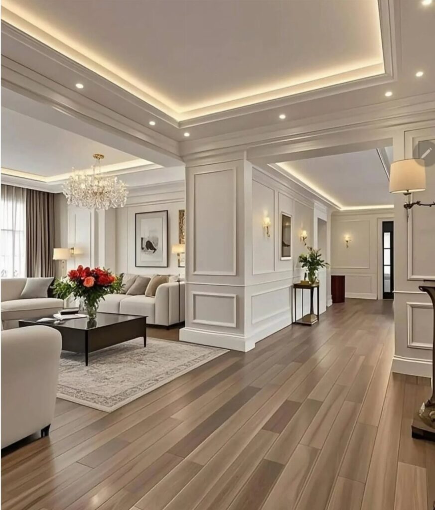 White wainscoting panels on walls in a modern living room with wooden floors and a chandelier.