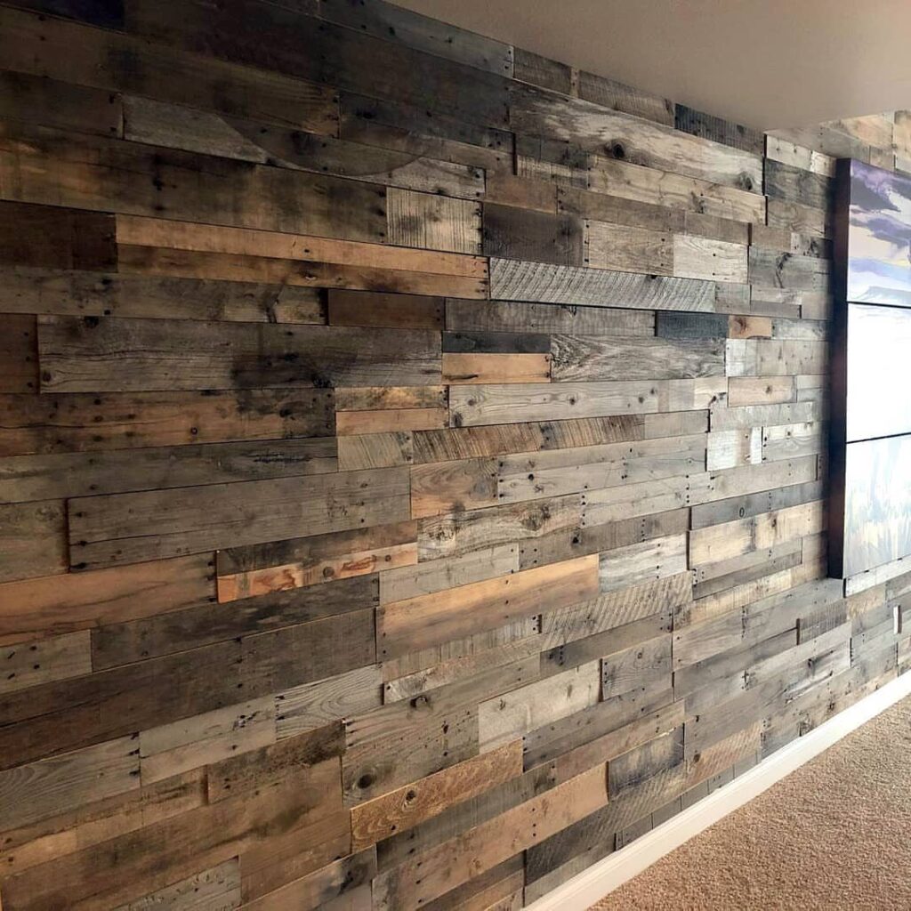 Reclaimed wood planks in various natural tones covering a large interior wall.