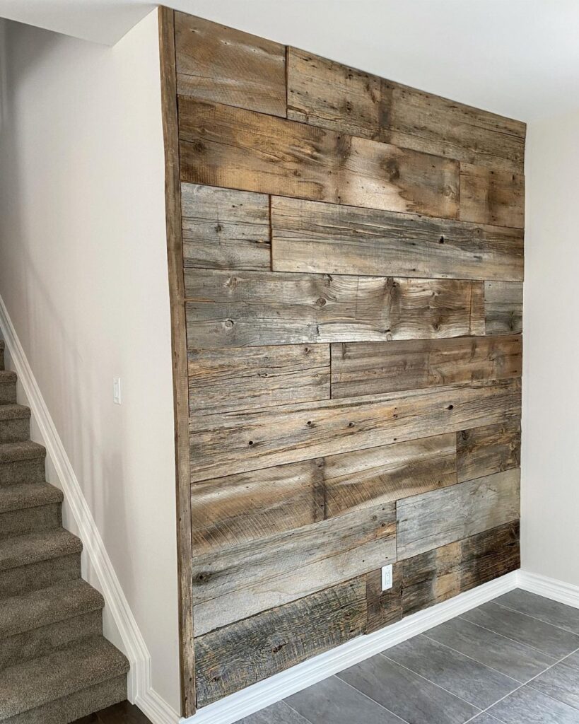 Reclaimed wooden planks arranged horizontally to create a textured accent wall in a home interior.
